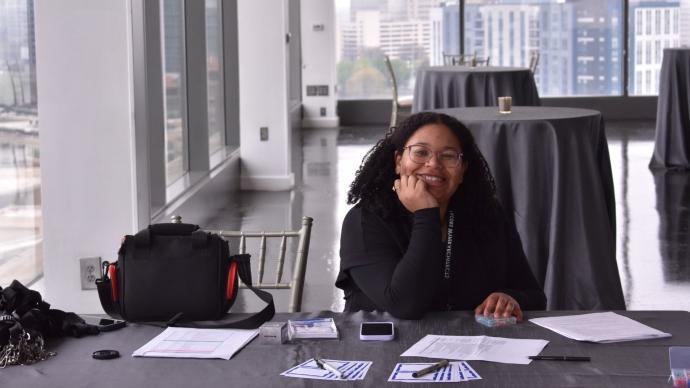 Camille Johnson sitts at a table in an office