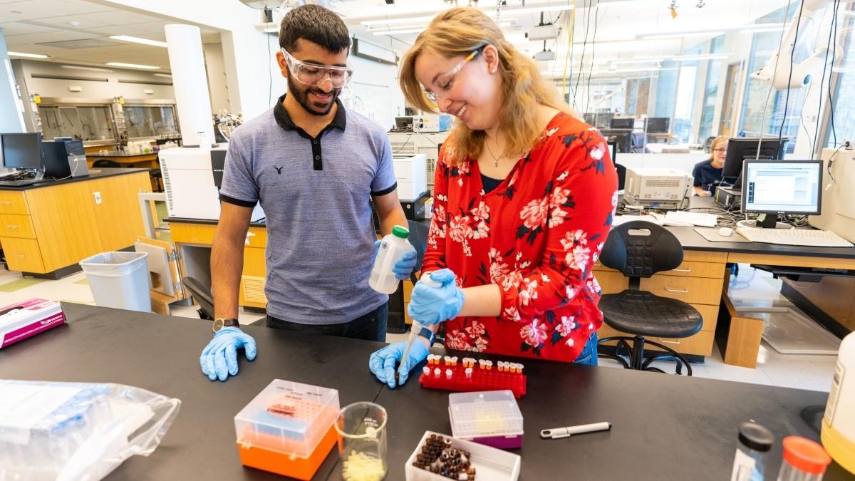 Professor and student conducting an experiment